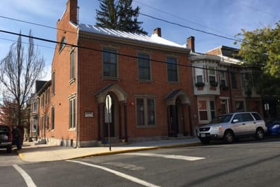 Corner brick building at 100 W. Pomfret St.