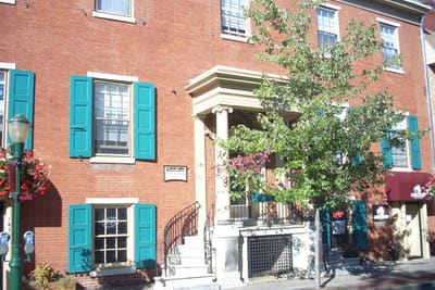 Brick building with teal shutters in downtown Carlisle