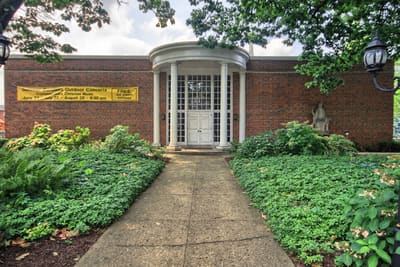 Brick building with a white columned rotunda entrance
